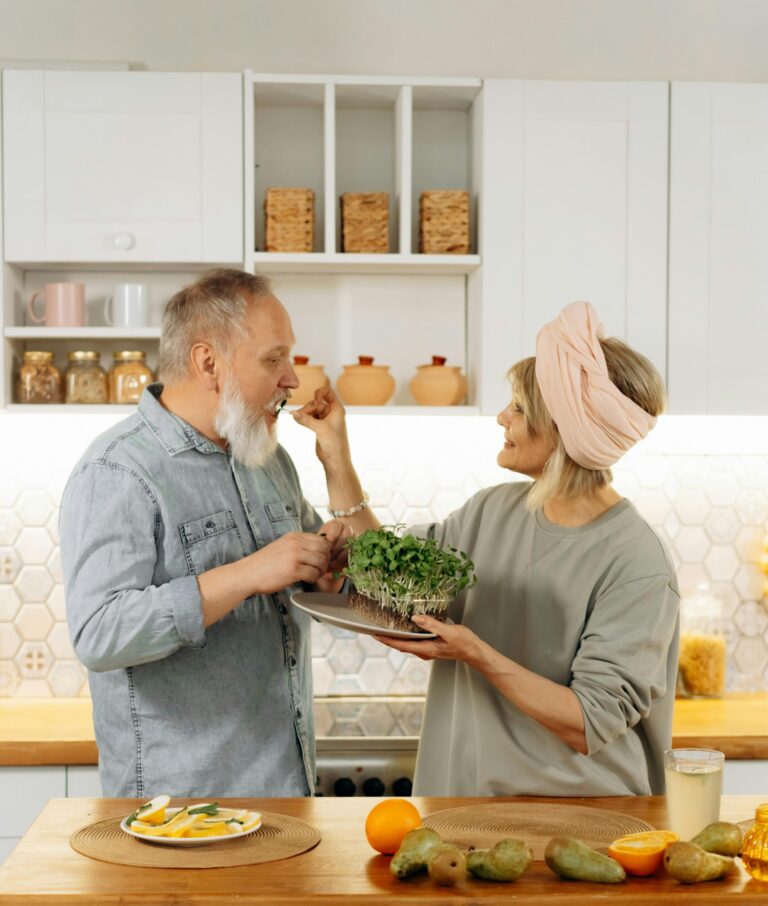 An older couple enjoying food and time together at home